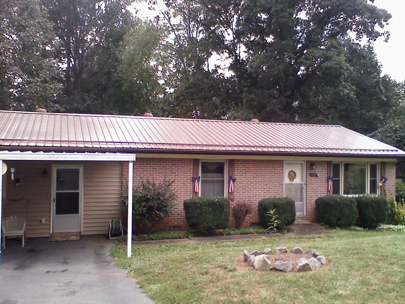 Bronze metal roof and carport on a brick ranch home — Roof Repair work by our crew in Redlands